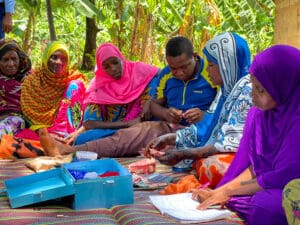 Members of the Mtende coastal community in Zanzibar gather to discuss local financial matters and community planning.